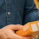 Shopper comparing product prices and labels in-store — a key step in accurate retail audits and pricing compliance with BARE International.